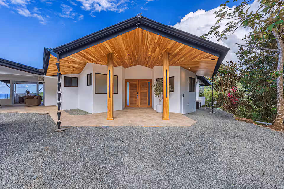 Outdoor dining area set among tropical gardens at KsaLinda villa